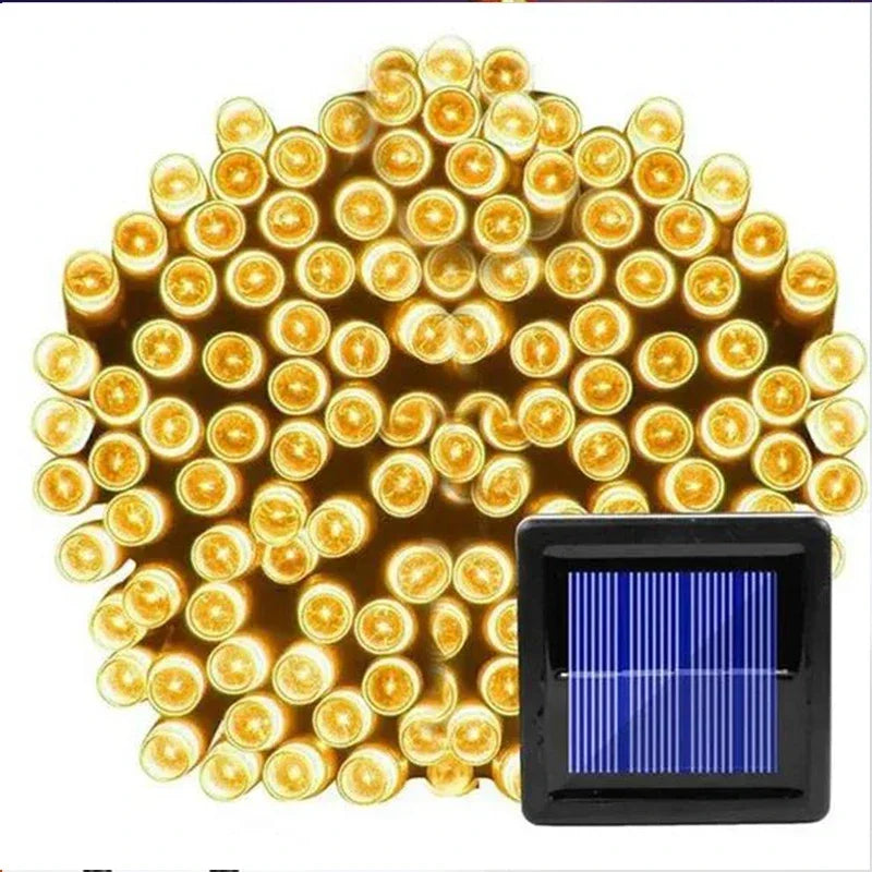A cluster of lit yellow LED string lights is shown with a small blue solar panel positioned at the bottom right, indicating the lights are solar-powered.