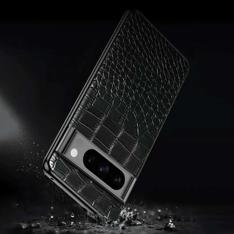 Black smartphone with a crocodile-textured leather back and triple camera setup, falling and splashing water on a dark background.