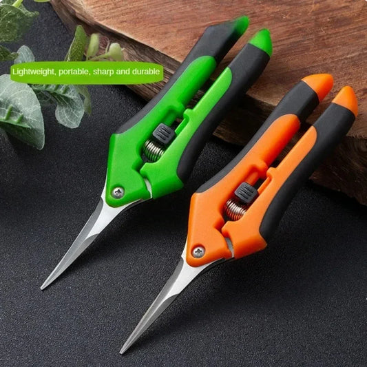 Two pairs of pruning shears with ergonomic handles, one green and one orange, are placed on a wooden surface next to some greenery. Text reads: "Lightweight, portable, sharp and durable."