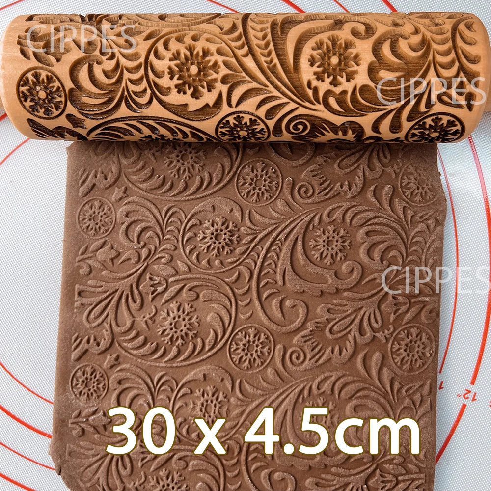 Embossed rolling pin with intricate floral design, rolling over brown dough with matching pattern. Dimensions 30 x 4.5cm displayed. White mat with red circles underneath.