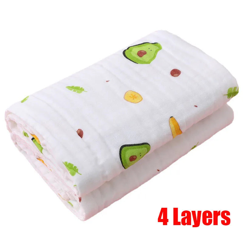 Folded white blanket with colorful avocado and leaf prints, featuring a "4 Layers" text in red, indicating its thickness and durability.