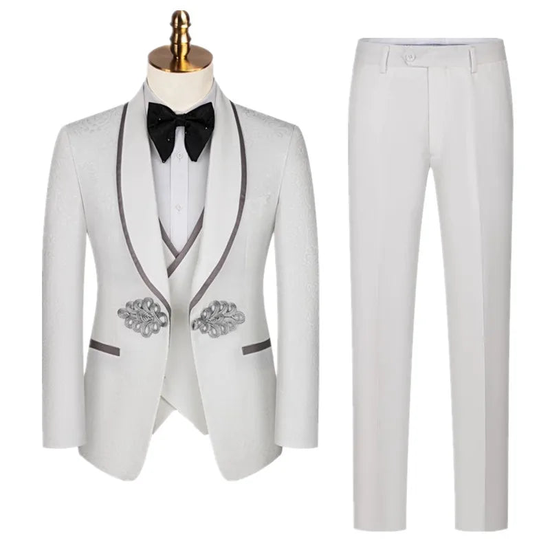 Elegant white suit with a tailored jacket and matching pants. The jacket features dark trim, ornate silver accents, and a classic black bow tie over a white shirt.