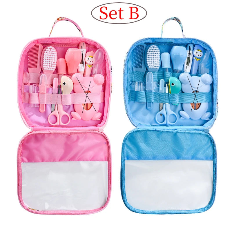 Two open baby grooming kits labeled Set B. The pink kit includes brushes and scissors, the blue kit holds similar items. Both cases have compartments and handles.