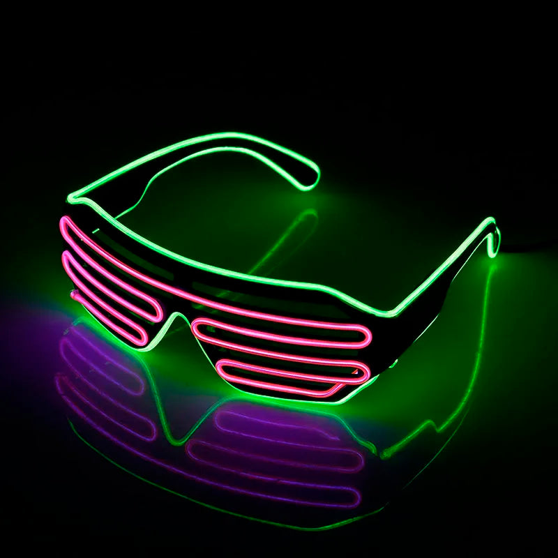 Neon-lit shutter shades featuring a green frame and pink slats glowing brightly in the dark, casting a colorful reflection on the surface below.