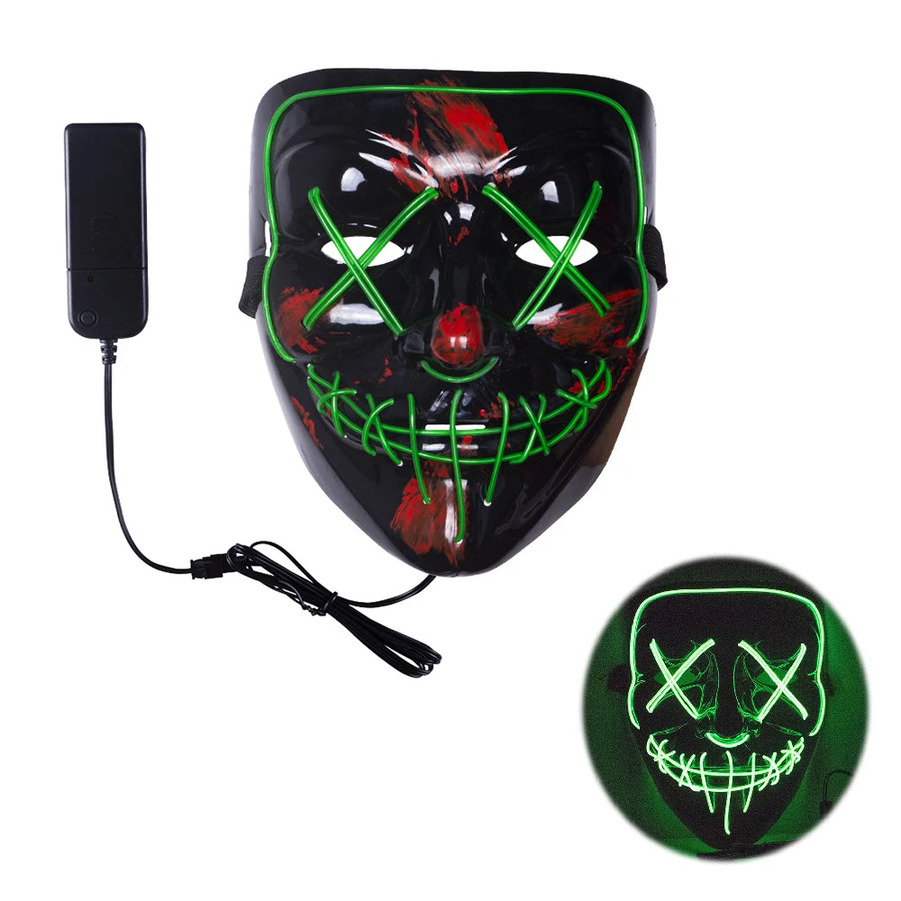 Black mask with glowing green wires forming Xs over eyes and a stitched mouth pattern. Red paint accents. Comes with a connected battery pack. Second image shows it illuminated in the dark.