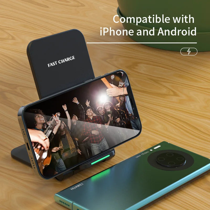 A smartphone on a fast charge stand displays a concert scene. Text reads "Compatible with iPhone and Android" on a wooden surface beside a smartphone with a green case.