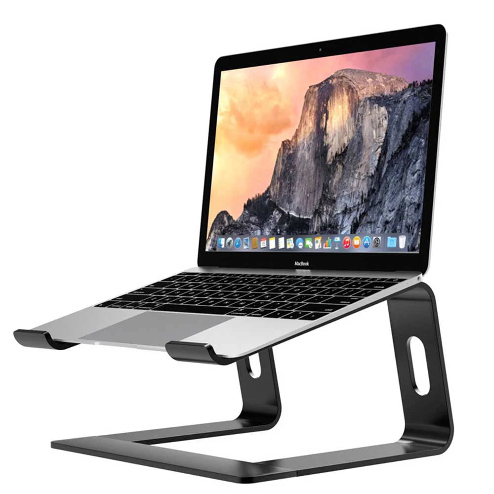 Laptop on a sleek metal stand, tilted for ergonomic viewing. The screen displays a scenic mountain wallpaper, and the device appears to be a MacBook.