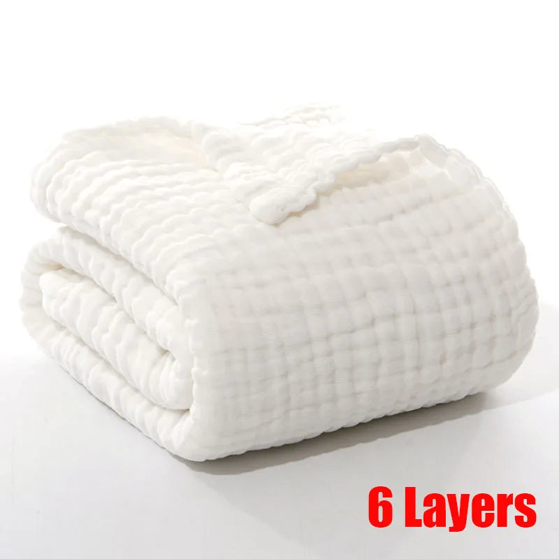 Folded white 6-layer blanket with a textured pattern, placed on a white surface. The text "6 Layers" in bold red letters is displayed at the bottom right corner.