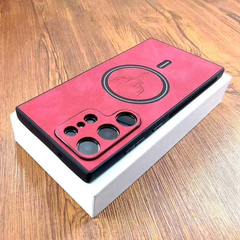 Red smartphone with multiple rear cameras and embossed logo, resting on a white box on a wooden surface.