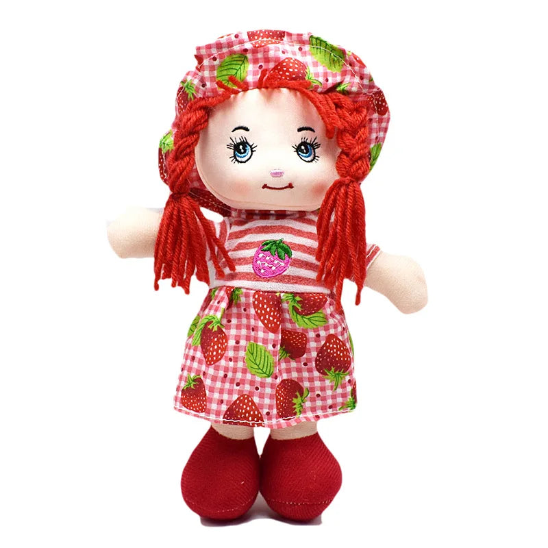 Cute plush doll with red yarn hair, wearing a strawberry-themed dress and matching hat. The outfit features red and white stripes, gingham, and bright red shoes.