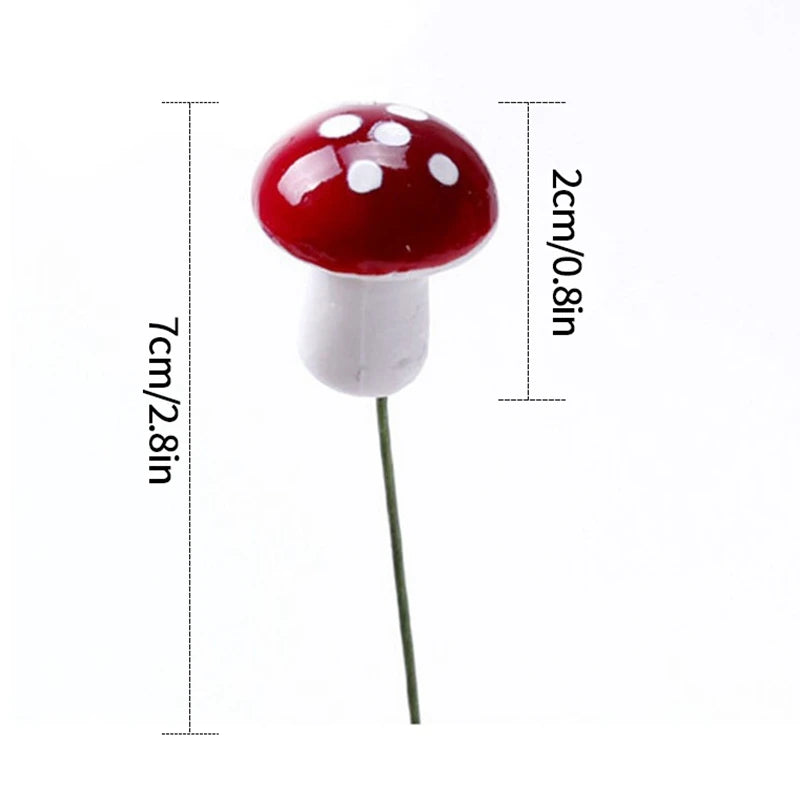 Red mushroom ornament with white spots, measuring 7cm in height with a 2cm cap diameter, atop a thin green stem against a white background.