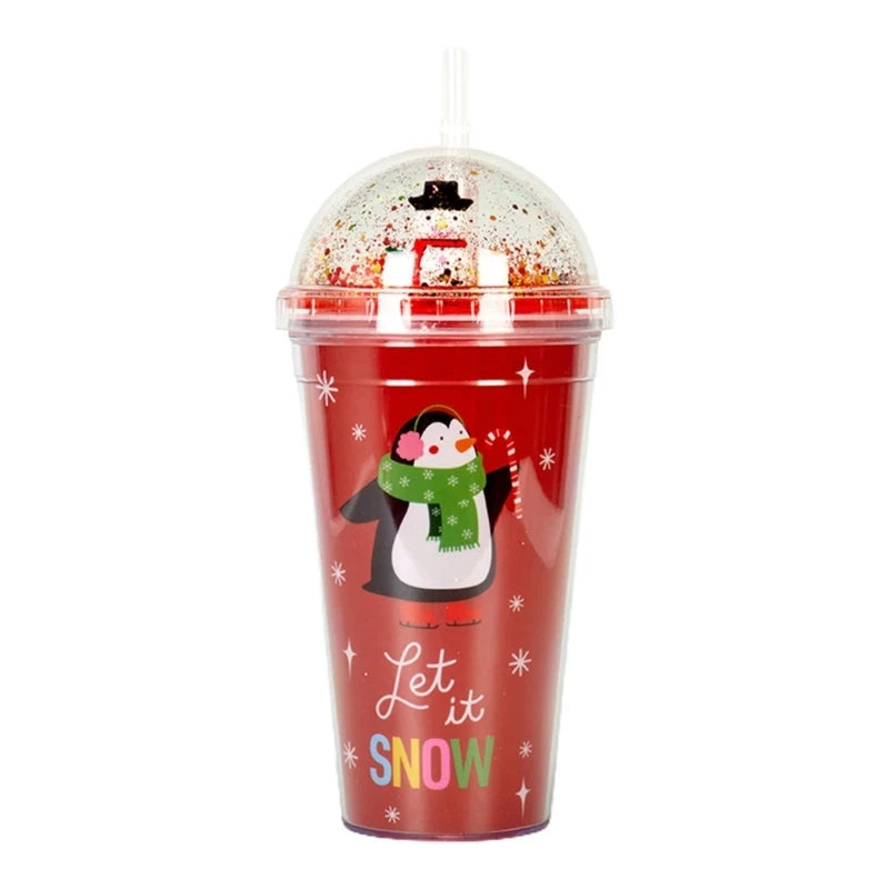 Red tumbler with festive penguin and "Let it Snow" text. Features a clear, sparkling dome lid and straw. Decorated with snowflakes and a green scarf on the penguin.