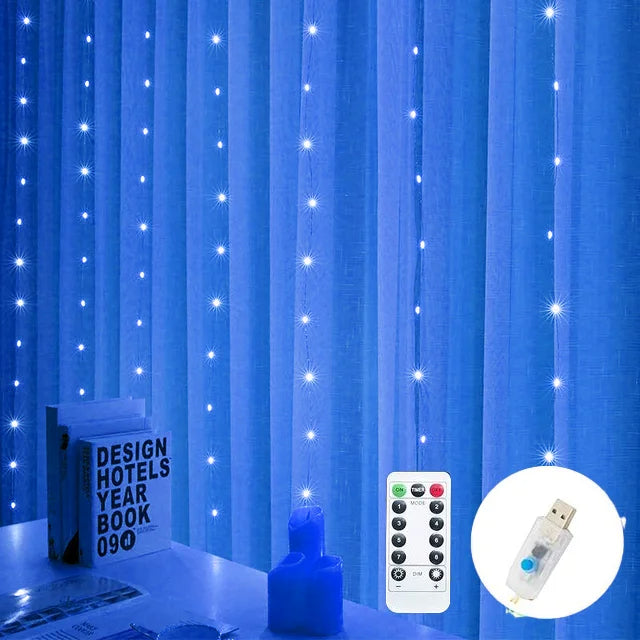Blue curtain with vertical strings of glowing LED lights. A remote control and USB plug are shown, with books and a candle on a table beneath the curtain.
