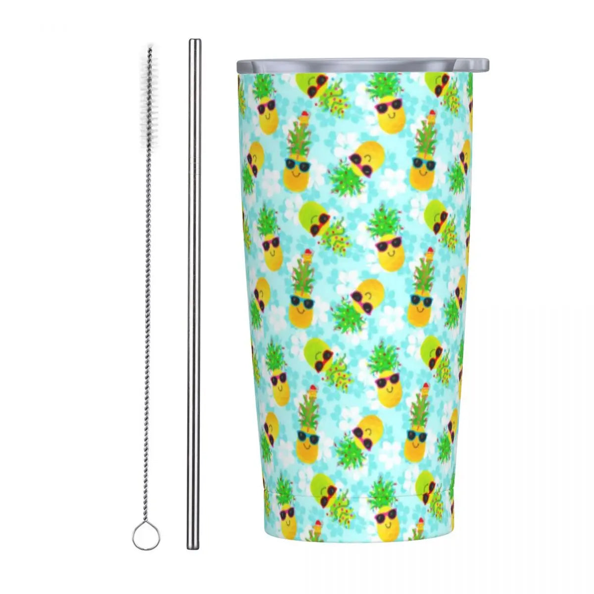 Colorful tumbler with pineapple wearing sunglasses pattern, accompanied by a metal straw and cleaning brush on a white background.