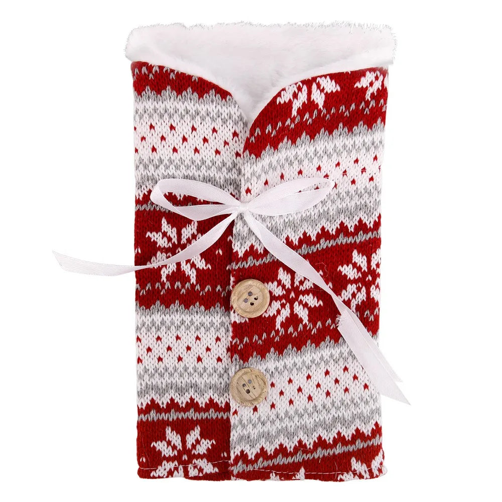 Red and white knitted sleeve with snowflake patterns, featuring two wooden buttons and a white ribbon tie. The interior is lined with soft white fabric.