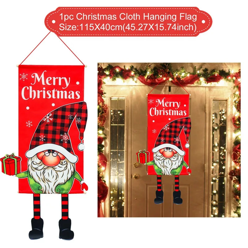 Red Christmas cloth hanging flag featuring a gnome in a plaid hat, holding a gift, with "Merry Christmas" text. Displayed on a festive door decorated with lights and garlands.