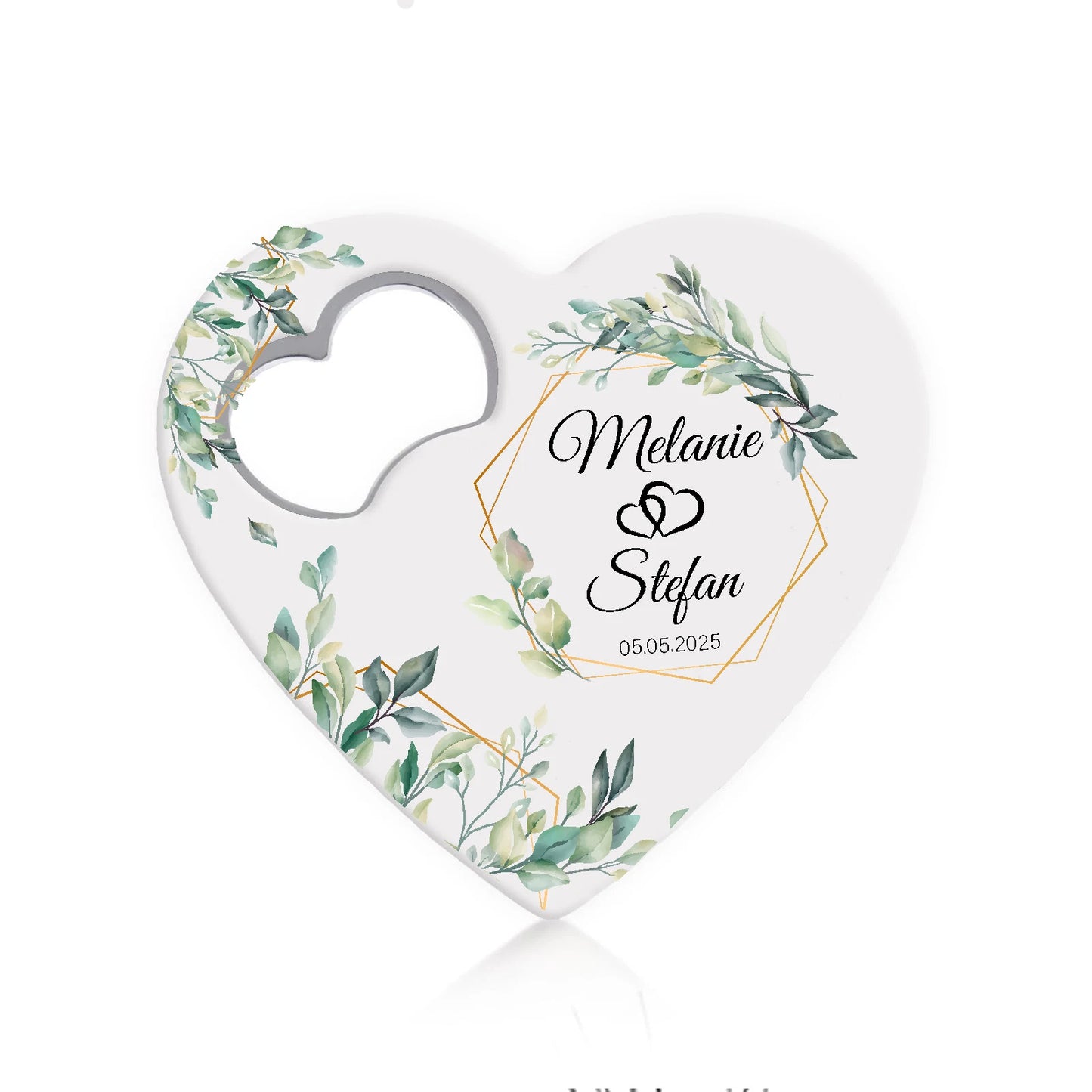 Heart-shaped favor with green foliage and geometric gold accents. Names "Melanie" and "Stefan" are in the center with interlocking rings and the date "05.05.2025" below.