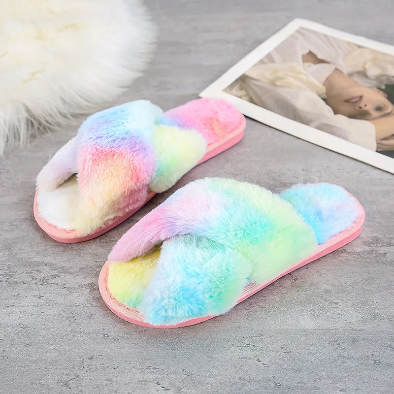 Cozy slippers with soft, multicolored fuzzy straps and pink soles on a grey floor, near a white faux fur rug and an open magazine displaying a fashion photo.