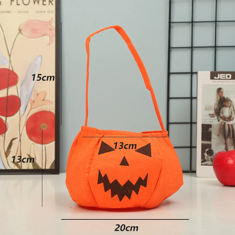 Orange pumpkin-shaped Halloween bag with a black jack-o'-lantern face. Dimensions are shown: 20cm wide, 15cm tall, 13cm deep. The background has decor and a red apple.