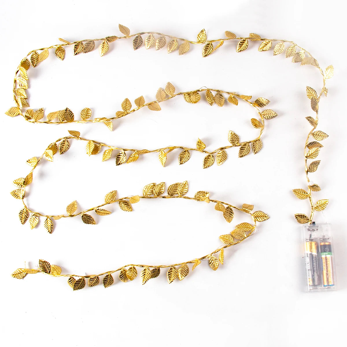 String of gold leaf garland lights powered by two AA batteries in a transparent case, arranged in a wavy pattern on a white background.