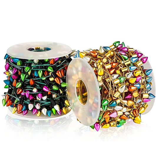 Two spools of colorful metallic spikes on strings; one with black string, the other gold. The spikes are in shades of pink, orange, green, blue, gold, and silver.