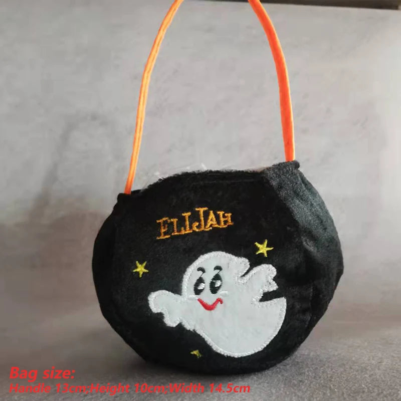 Black Halloween bag with an orange handle, featuring a white smiling ghost and stars. Personalized with "ELIJAH" stitched in yellow. Bag size: Handle 13cm; Height 10cm; Width 14.5cm.