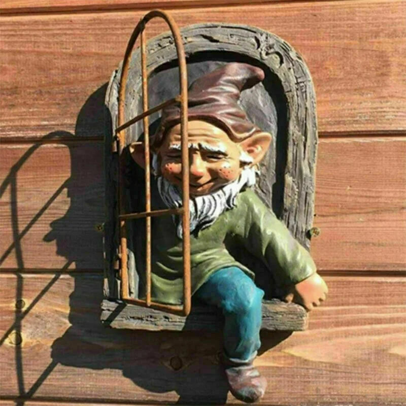 A whimsical garden gnome peeks out from a wooden window frame, leaning with one leg dangling and wearing a pointed hat. The background is a wooden wall with visible grain.