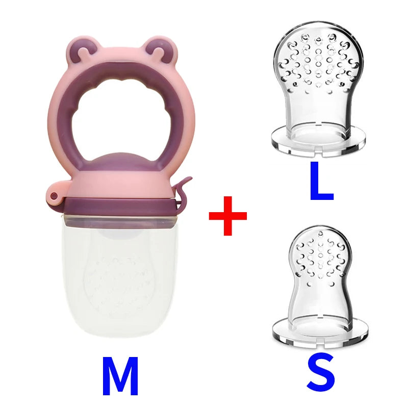 Pink baby food feeder with an easy-grip handle, shown alongside two silicone replacement nipples labeled L and S for different sizes, with a plus sign in between.