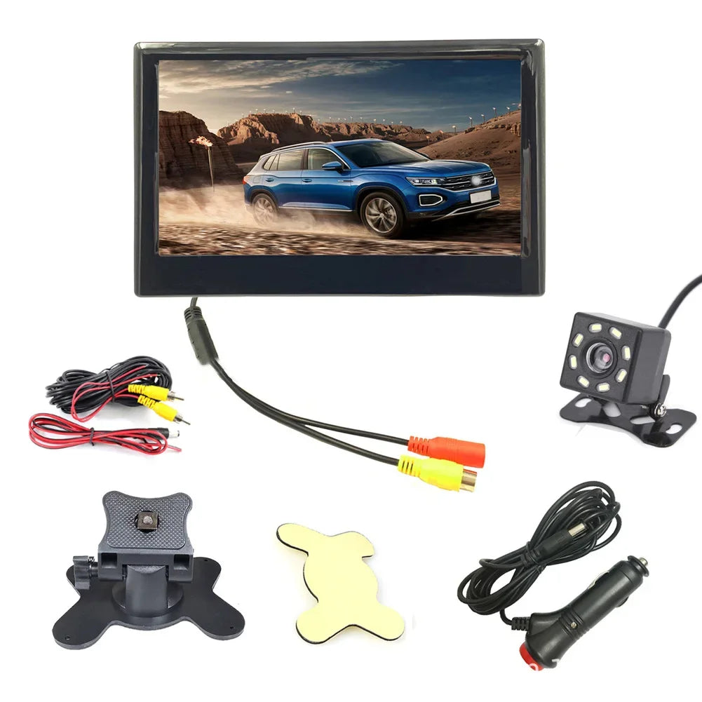 Car rearview backup camera kit with a monitor displaying a blue SUV, camera, mounting bracket, adhesive pad, power cables, and cigarette lighter adapter.