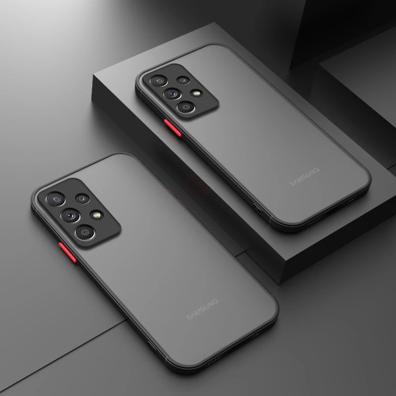 Two Samsung smartphones with sleek black designs and triple camera setups are displayed on dark geometric surfaces, highlighting red accents on their side buttons.