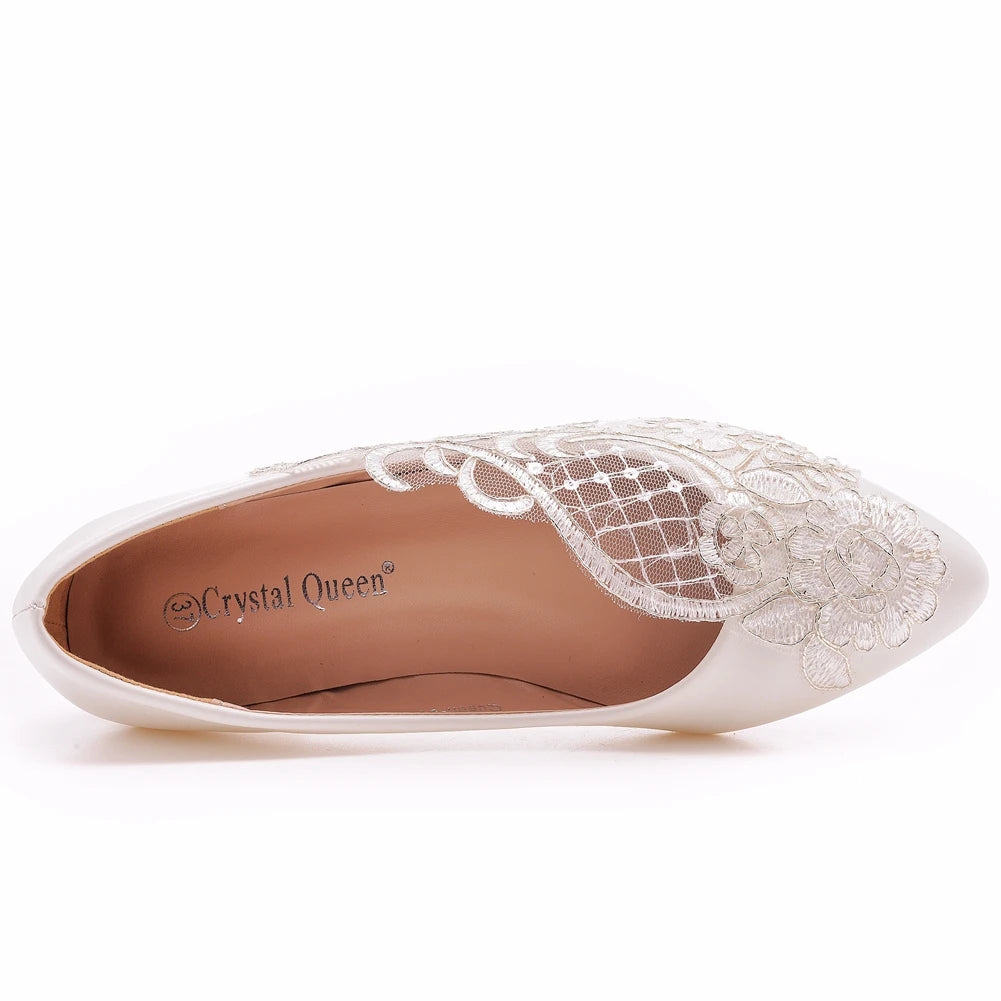 Top view of an elegant ivory shoe with intricate lace floral embroidery and mesh detail, branded "Crystal Queen" on the insole, suitable for formal occasions.