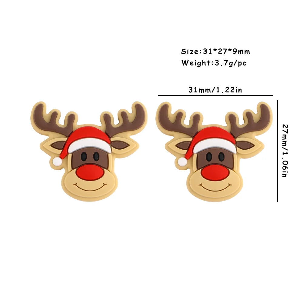 Cartoon reindeer head wearing a red Santa hat. Two identical designs are shown with dimensions: 31x27x9mm and weight 3.7g each.