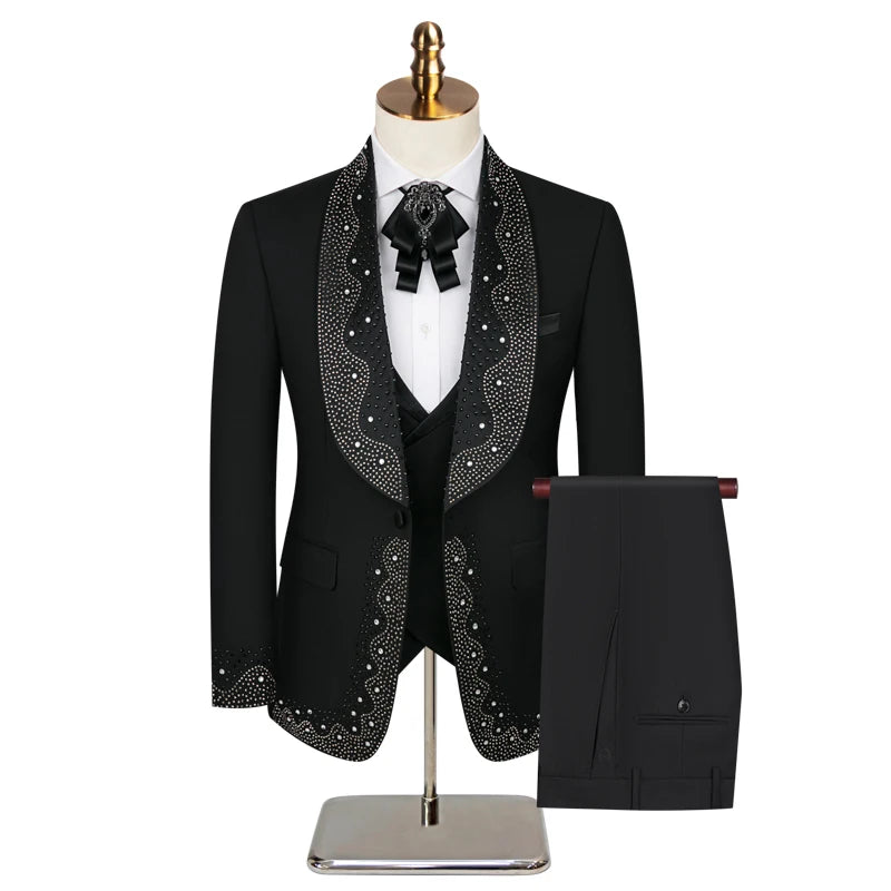 Black mariachi suit on a mannequin, featuring intricate silver embroidery on the lapels and cuffs, a white shirt with a black bow tie, and matching black pants.