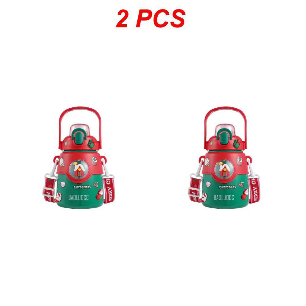 Two red and green Christmas-themed containers with handles, featuring a festive design with a window showing a small figure. Text "2 PCS" above in red.