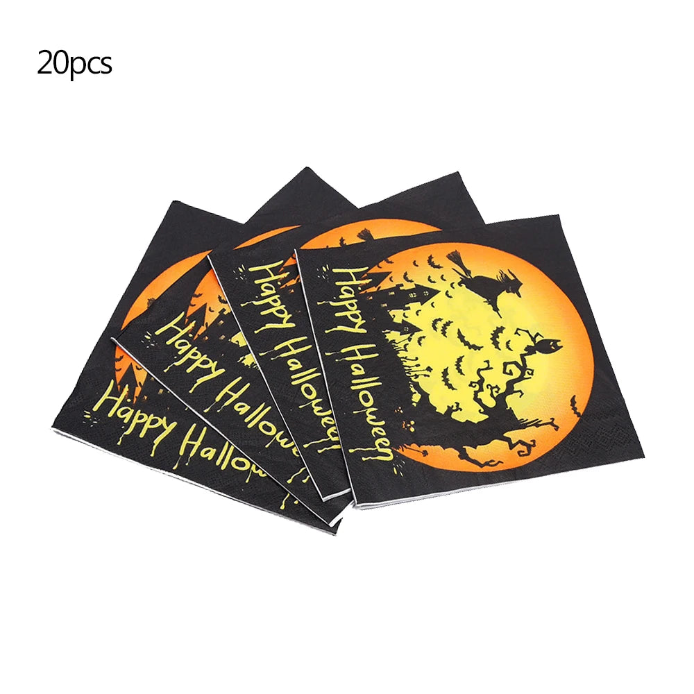 Stack of Halloween napkins with black and orange design featuring silhouettes of a witch, bats, and trees against a full moon. Text reads "Happy Halloween." Set of 20 napkins.