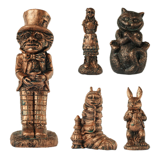 Five bronze figurines featuring whimsical characters, including a top-hat wearer, a girl, a grinning cat, a caterpillar with a pipe, and a rabbit in a suit.