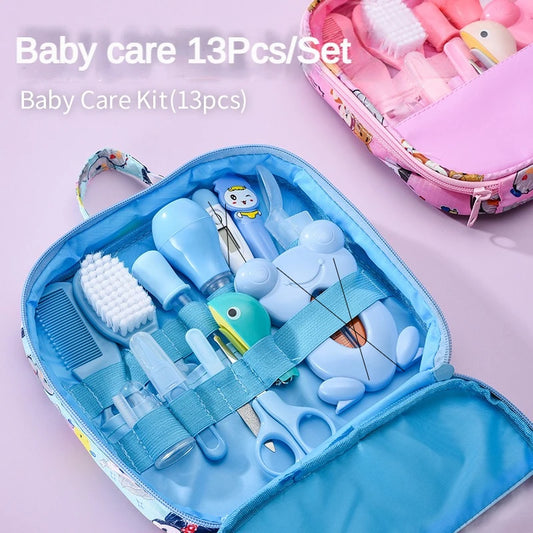 Blue and pink baby care kits open to show contents, including brushes, scissors, and a bulb syringe. Each set contains 13 items, visually organized in zipped cases.