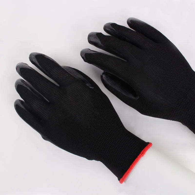 A pair of black gloves with a textured surface and red trim on the wrist, displayed on a white background.