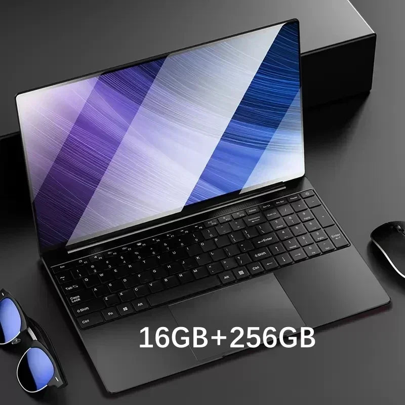 Sleek black laptop with a colorful screen, black keyboard, and the specs "16GB+256GB" displayed. Nearby are sunglasses and a wireless mouse, set on a dark surface.