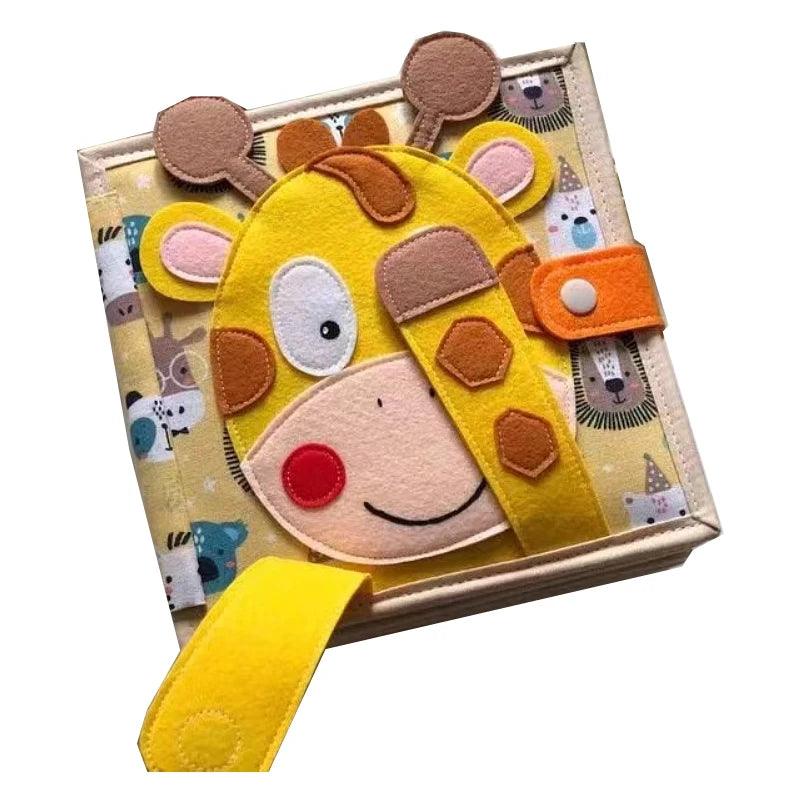 Soft fabric activity book featuring a cute felt giraffe with tactile elements, like a slide-on strap and button flap, set against a colorful animal-themed background.
