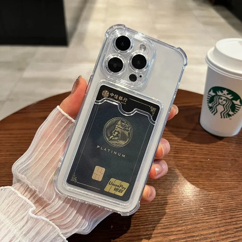 A hand holds a smartphone with a transparent case that has a card slot, containing a platinum UnionPay card. A Starbucks cup is on a wooden table in the background.