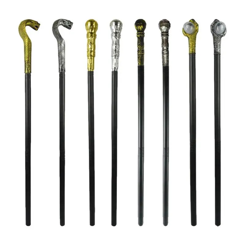 A collection of eight black walking canes with ornate metallic handles in various designs, including silver and gold snakes, domed caps, and intricate patterns.