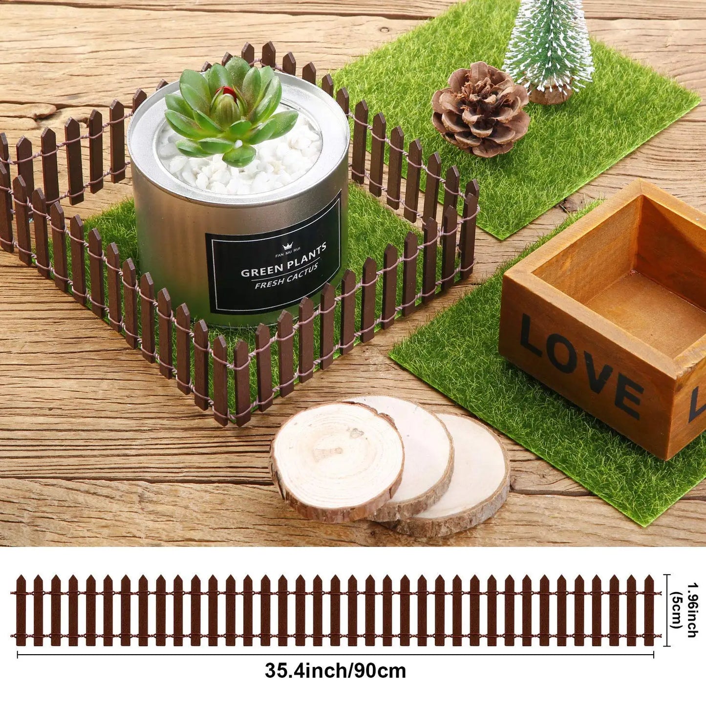 Miniature garden set with a wooden fence enclosing a cactus in a metal pot on grass, alongside a pine cone, tree, wooden slices, and a "LOVE" box. Fence dimensions: 35.4" x 1.96".