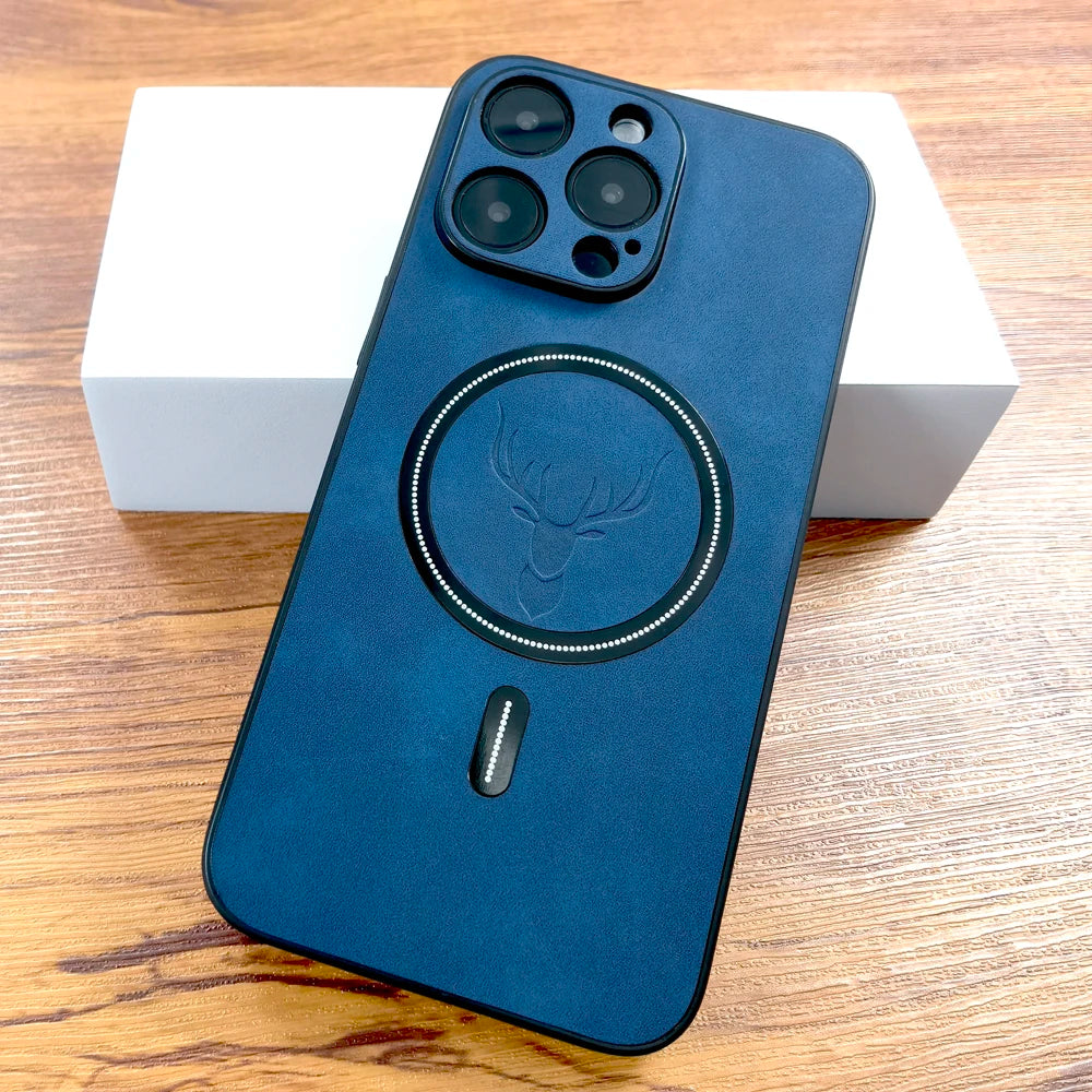 A smartphone with a blue case featuring a circular deer design and MagSafe compatibility is placed on a wooden surface beside a white box.