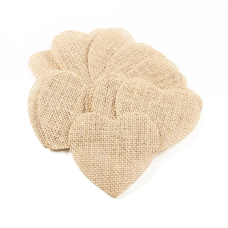 A stack of burlap heart-shaped cutouts laid out against a white background, showcasing the coarse, woven texture of the fabric.