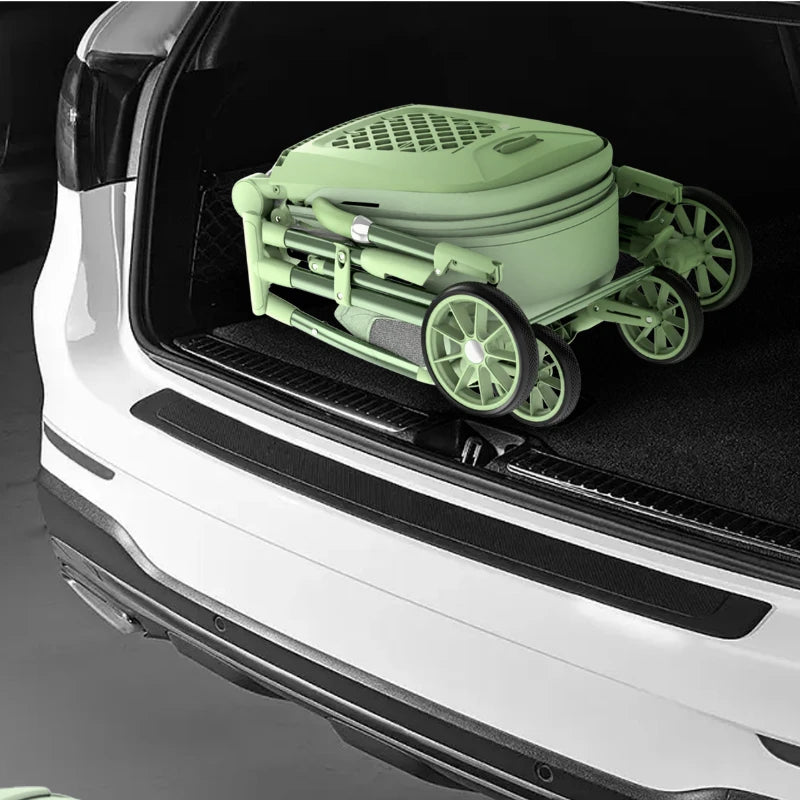 A folded green portable stroller in the trunk of a white car, showcasing compact storage and transport convenience.