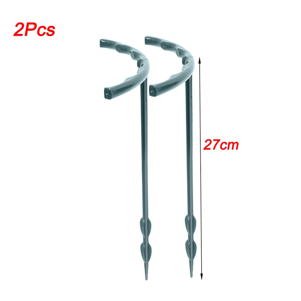 Two black 27cm-long anchor stakes with curved tops displayed on a white background. Text "2Pcs" in red on the upper left.
