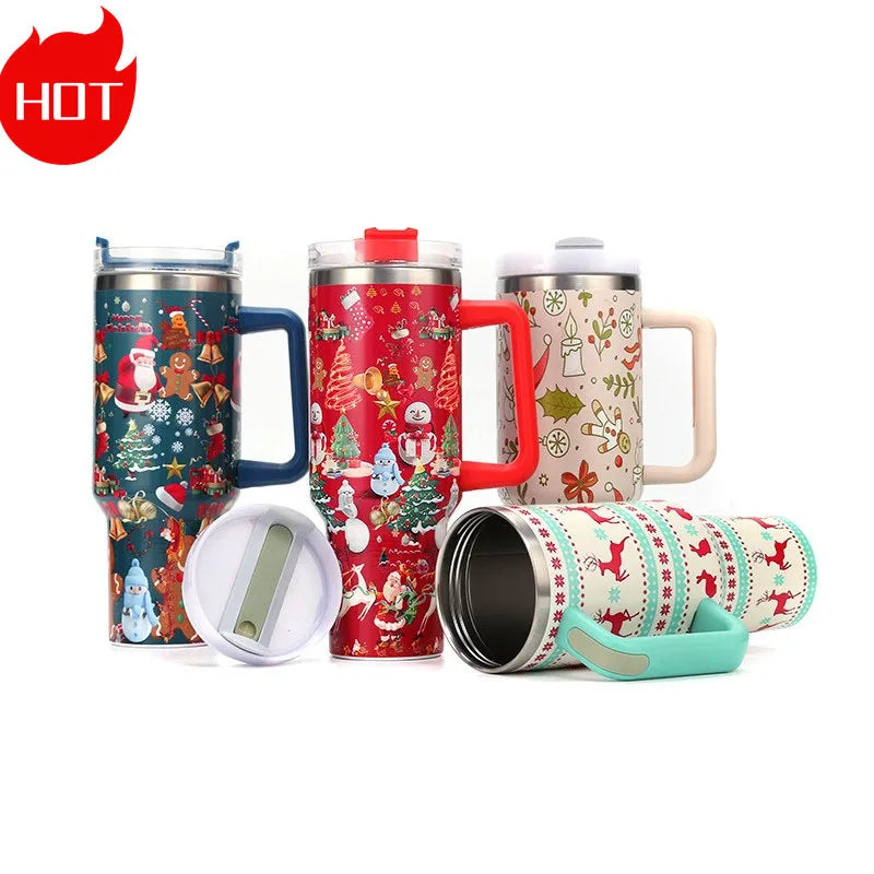 Festive travel mugs with Christmas designs, including Santa, snowmen, and reindeer, in assorted colors. One mug is horizontal, showing the stainless steel interior.