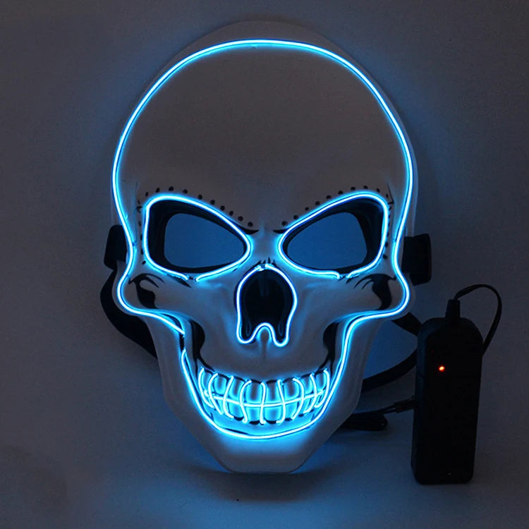 White skull mask with glowing blue neon outlines around the eyes, nose, and mouth. The mask is attached to a black strap and connected to a black power source with a red indicator.