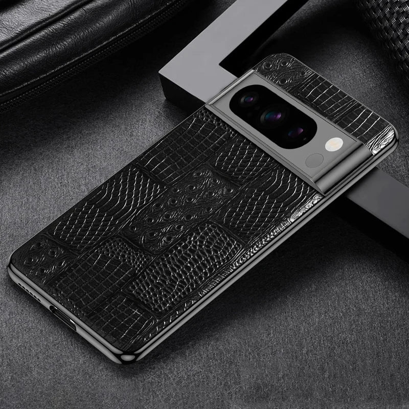 A smartphone with a black textured back cover featuring a crocodile pattern, positioned diagonally on a dark surface with sleek metallic edges and dual cameras.